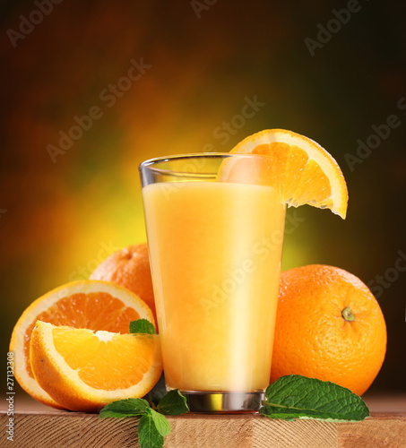 Photo: Oranges and glass of juice. Oranges and glass of juice.