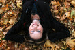 Photo: Woman laying in autumn leaves Woman laying in autumn leaves