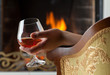 Resting at the burning fireplace fire with a glass of cognac