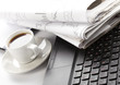 Cup of fragrant coffee on a morning paper business news
