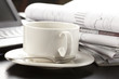 Cup of fragrant coffee on a morning paper business news Cup of fragrant coffee on a morning paper business news