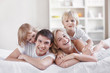 Smiling parents with children at home