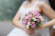 Bride holding pink wedding flowers bouquet