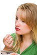 Woman applying lip-gloss with lip brush