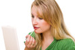 Young woman putting on lipstick, looking in the mirror