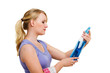 Woman holding a spray bottle of blue cleaning solution against w
