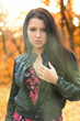 The girl brunette in autumn wood