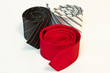 three male tie rolled up on a white three male tie rolled up on a white