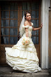 Portrait of bride near glass door of old pavilion