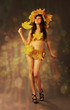 Girl wearing autumn leaves.