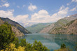 Colorful lake with mountains, sky and clouds