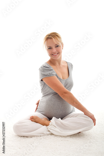 Photo: Beautiful pregnant woman doing exercises Beautiful pregnant woman doing exercises