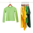 Green and yellow shirts on wooden hangers Green and yellow shirts on wooden hangers