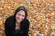 Photo: Woman sitting in autumn leaves Woman sitting in autumn leaves