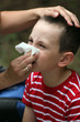 Child blowing nose. Child with tissue. catarrh or allergy