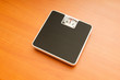 Dieting concept with scales on the wooden floor