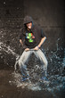 Hip-hop dancer in aqua studio showin his tongue