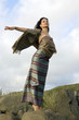 woman in national Thai clothes costs highly on a rock woman in national Thai clothes costs highly on a rock