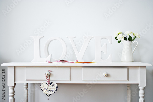 Photo: "love" decorations, ribbon, roses and card on desk "love" decorations, ribbon, roses and card on desk