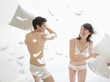 couple in underwear enjoying pillow fight