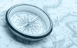 Old compass on ancient map