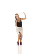Young woman with microphone dancing and singing