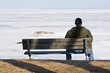 sad man on a bench in winter
