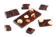Pieces of milk chocolate bar with nuts isolated on white Pieces of milk chocolate bar with nuts isolated on white