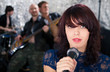 Beautiful rock singer with her band in the background