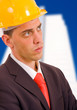 Young architect wearing a protective helmet standing in front of