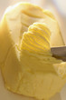 knife scraping pat of butter