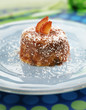 Biscuit pudding soaked in strawberry juice witn coconut flakes