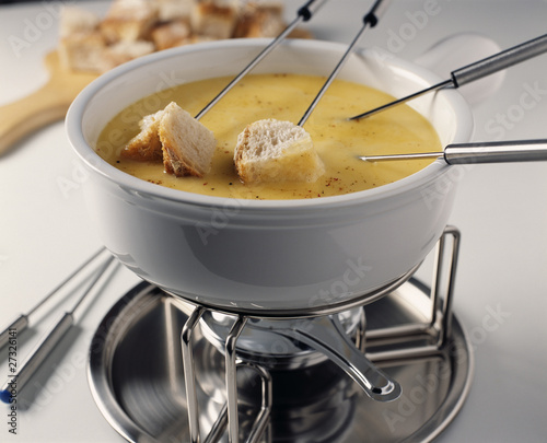 Photo : Diping the bread into the Fondue Diping the bread into the Fondue