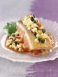 Piece of salmon cooked on one side with crushed vegetables,apples and capers