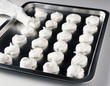 shaping meringues on a tray 