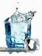 Ice cube falling in a glass of water