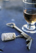 Glass of rosé wine and corkskrew