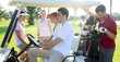 Golf course young people group buggy green field Golf course young people group buggy green field