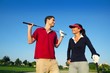 Golf course young happy couple players couple talking Golf course young happy couple players couple talking