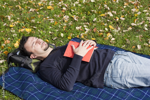Photo: Young Adult Relaxing in the Park during a Weekend Afternoon Young Adult Relaxing in the Park during a Weekend Afternoon