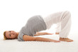 Beautiful pregnant woman doing exercises on the floor