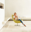 Happy relaxed female drinking coffee at an empty modern room Happy relaxed female drinking coffee at an empty modern room