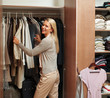 Happy mature female making choices in wardrobe Happy mature female making choices in wardrobe