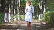 Young woman walking in park. Two versions sequentially.