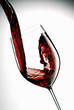 pour red wine into a glass with white background