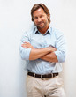 Portrait of a smart mature man smiling with hands folded Portrait of a smart mature man smiling with hands folded