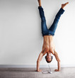 Handstand - Crazy man listening to music on headphones