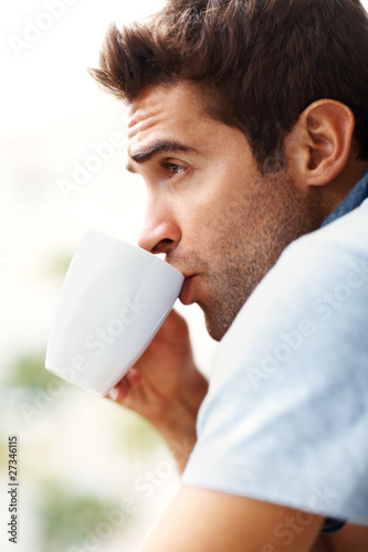 Photo: Relaxed young man drinking coffee Relaxed young man drinking coffee