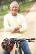 Senior man riding bicycle in park