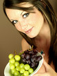 Young Woman Holding Bowl of Grapes. Model Released